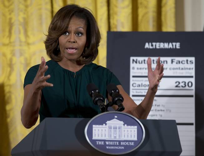First lady Michelle Obama gestures as she speaks in the East Room of the White House in Washington, Thursday, Feb. 27, 2014, about helping parents and other consumers make healthier choices as part of her Let's Move program. The Obama administration is proposing new food labels that would make it easier to know about calories and added sugars, a reflection of the shifting science behind nutrition.