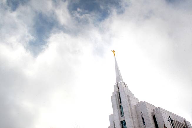 This December 2007 file photo, shows the Mormon Temple in Rexburg, Idaho. A newly-posted article, part of a series of recent online articles posted on the website of The Church of Jesus Christ of Latter-day Saints, affirms the Mormon faith's belief that humans can become like God in eternity, but explains that the "cartoonish image of people receiving their own planets" is not how the religion envisions it.