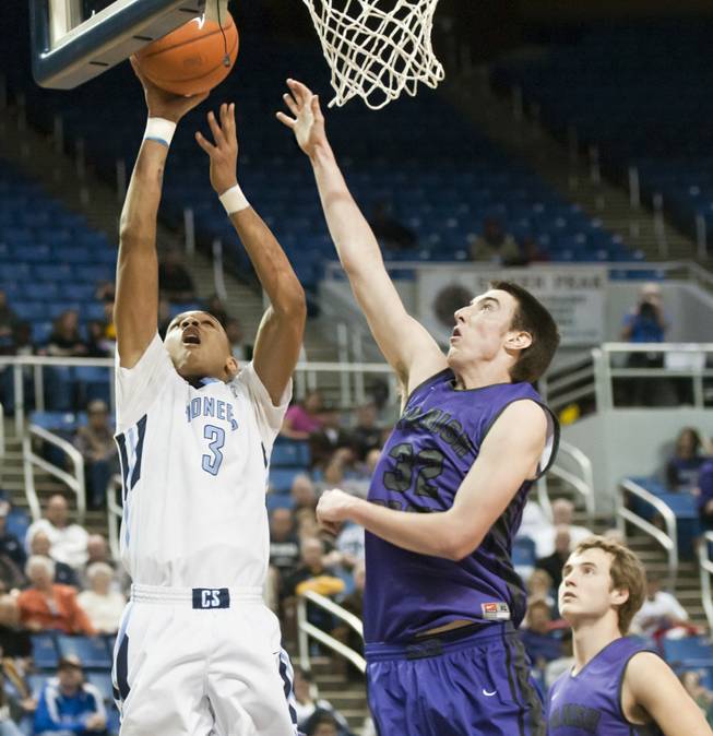 Jordan Davis forces in a layup over Jake Keady Thursday, Feb. 27, 2014 as Canyon Springs defeats Spanish Springs 66-51 in the semifinals of the Nevada State Championships at Lawlor Events Center in Reno.