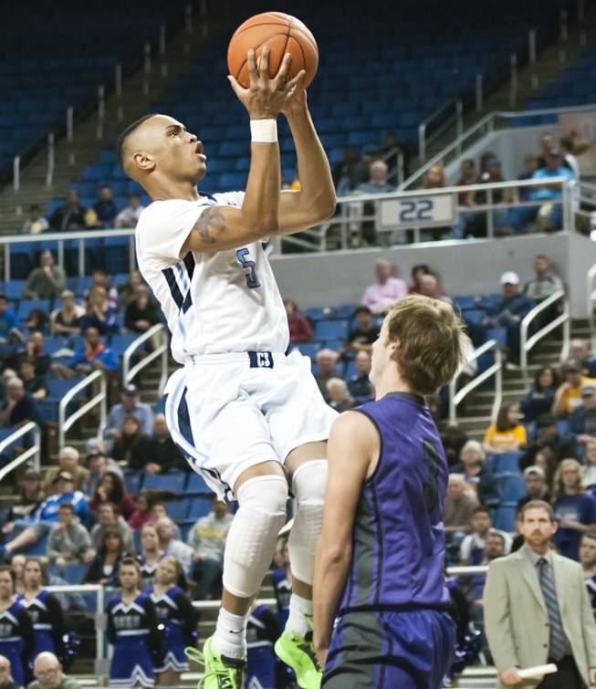 Gerad Davis eyes the hoop for a layup as a defender sneaks in beneath him Thursday, Feb. 27, 2014 as Canyon Springs defeats Spanish Springs 66-51 in the semifinals of the Nevada State Championships at Lawlor Events Center in Reno.