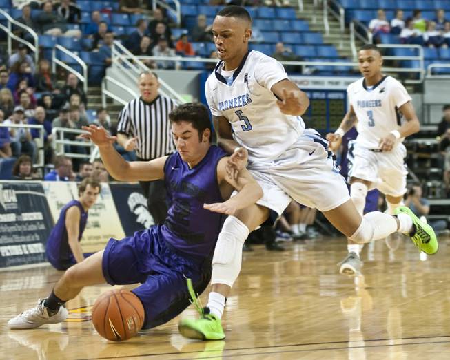 Gerad Davis, right, hustles after a ball as Hunter Pinto dives to the floor Thursday, Feb. 27, 2014 as Canyon Springs defeats Spanish Springs 66-51 in the semifinals of the Nevada State Championships at Lawlor Events Center in Reno.