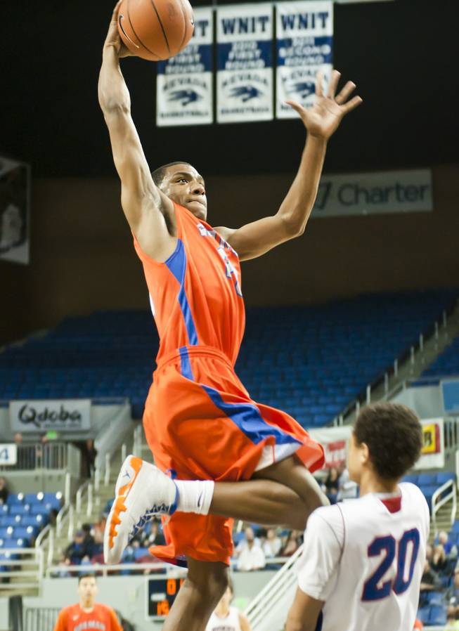 Nick Blair rises above a defender for a one-handed jam Thursday, Feb. 27, 2014 as Bishop Gorman defeats Reno 68-27 in the semifinals of the Nevada State Championships at Lawlor Events Center in Reno.