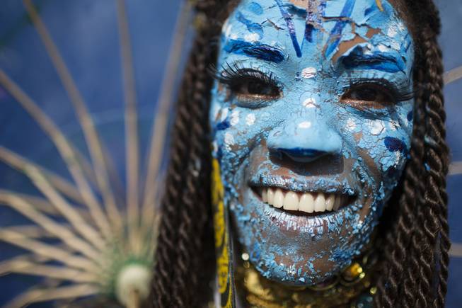 A reveler dressed as a character from the movie Avatar poses for a photo at the 'Ceu na Terra' block party during Carnival celebration in Rio de Janeiro, Brazil, Saturday, March 1, 2014. Rio de Janeiro's over-the-top Carnival is the highlight of the year for many local residents. Hundreds of thousands of merrymakers will take to Rio's streets in the nearly 500 open-air "bloco" parties. 