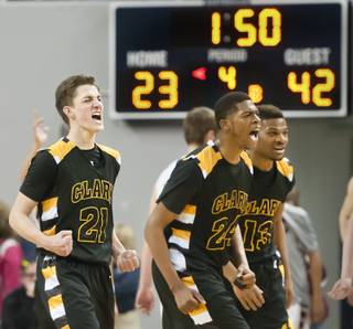 From left: Carter Olsen, Diontae Jones and Ty'Rek Wells let out a roar heading into a timeout as the final minutes tick off the clock Saturday, March 1, 2014 as Clark High School defeated Elko High School 43-25 winning the Division I-A state championship at Lawlor Event Center in Reno.