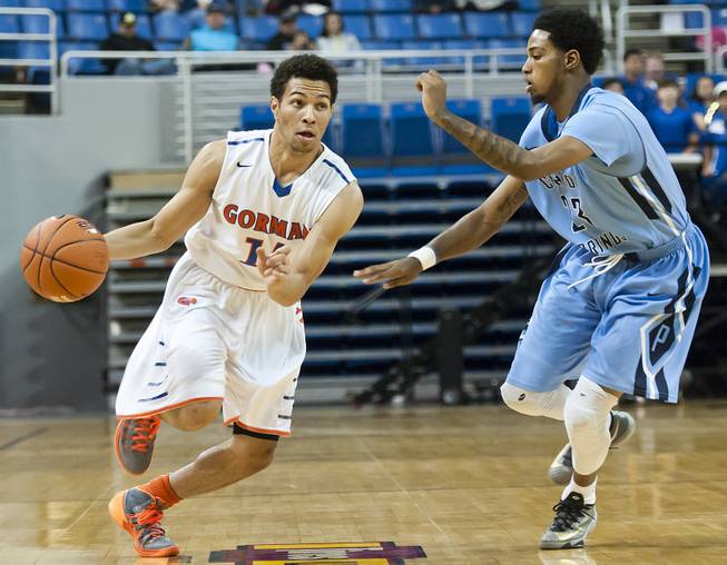 Noah Robotham, left, dribbles past Shaquile Carr Friday, Feb. 28, 2014 as Bishop Gorman defeated Canyon Springs 71-58 in the Nevada state championship game at Lawlor Event Center in Reno.