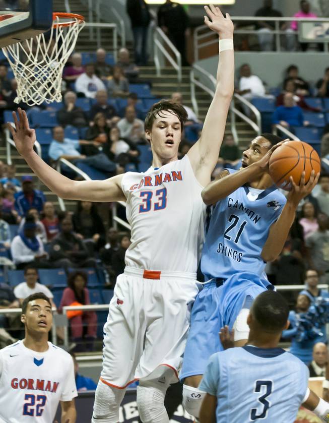 Darrell McCall, right, runs into defender Stephen Zimmerman on his way to a shot in the lane Friday, Feb. 28, 2014 as Bishop Gorman defeated Canyon Springs 71-58 in the Nevada state championship game at Lawlor Event Center in Reno.