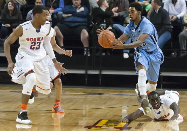 Shaquile Carr comes up with a loose ball as a defender is left beneath his feet Friday, Feb. 28, 2014 as Bishop Gorman defeated Canyon Springs 71-58 in the Nevada state championship game at Lawlor Event Center in Reno.