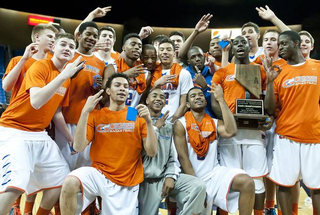 Bishop Gorman celebrates with their third consecutive state championship trophy Friday, Feb. 28, 2014 as Bishop Gorman defeated Canyon Springs 71-58 in the Nevada state championship game at Lawlor Event Center in Reno.