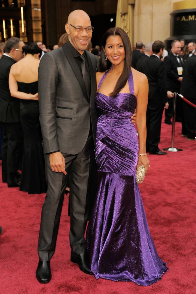 John Ridley, left, and Gayle Ridley arrives at the Oscars on Sunday, March 2, 2014, at the Dolby Theatre in Los Angeles.  (Photo by Chris Pizzello/Invision/AP)
