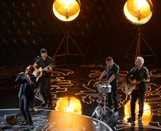 Bono, from left, The Edge, Larry Mullen, Jr., and Adam Clayton of U2 perform during the Oscars at the Dolby Theatre on Sunday, March 2, 2014, in Los Angeles.  (Photo by John Shearer/Invision/AP)