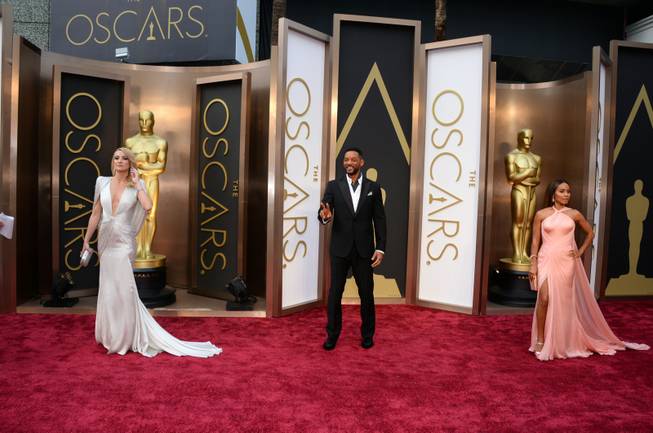 Kate Hudson, from left, Will Smith, and Jada Pinkett Smith arrive at the Oscars on Sunday, March 2, 2014, at the Dolby Theatre in Los Angeles.  (Photo by Jordan Strauss/Invision/AP)