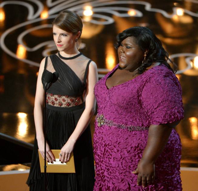Presenters Anna Kendrick, left, and Gabourey Sidibe speak during the Oscars at the Dolby Theatre on Sunday, March 2, 2014, in Los Angeles.  (Photo by John Shearer/Invision/AP)