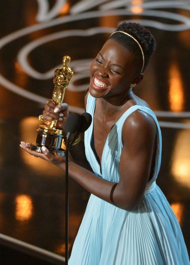 Lupita Nyongo accepts the award for best actress in a supporting role for "12 Years a Slave" during the Oscars at the Dolby Theatre on Sunday, March 2, 2014, in Los Angeles.  (Photo by John Shearer/Invision/AP)
