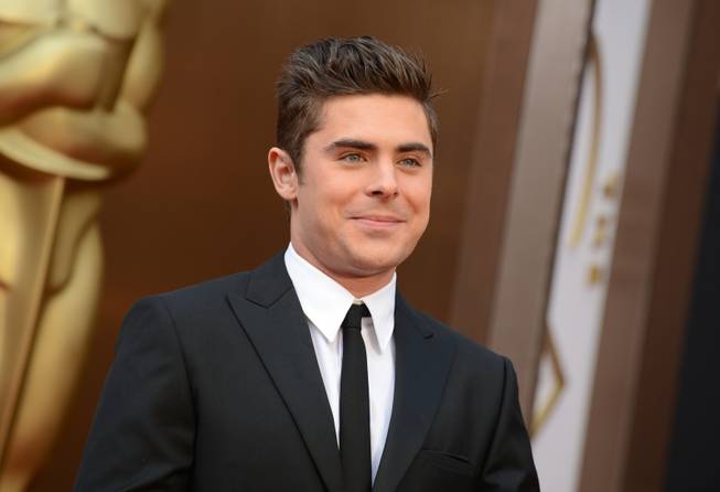 Zac Efron arrives at the Oscars on Sunday, March 2, 2014, at the Dolby Theatre in Los Angeles.  (Photo by Jordan Strauss/Invision/AP)