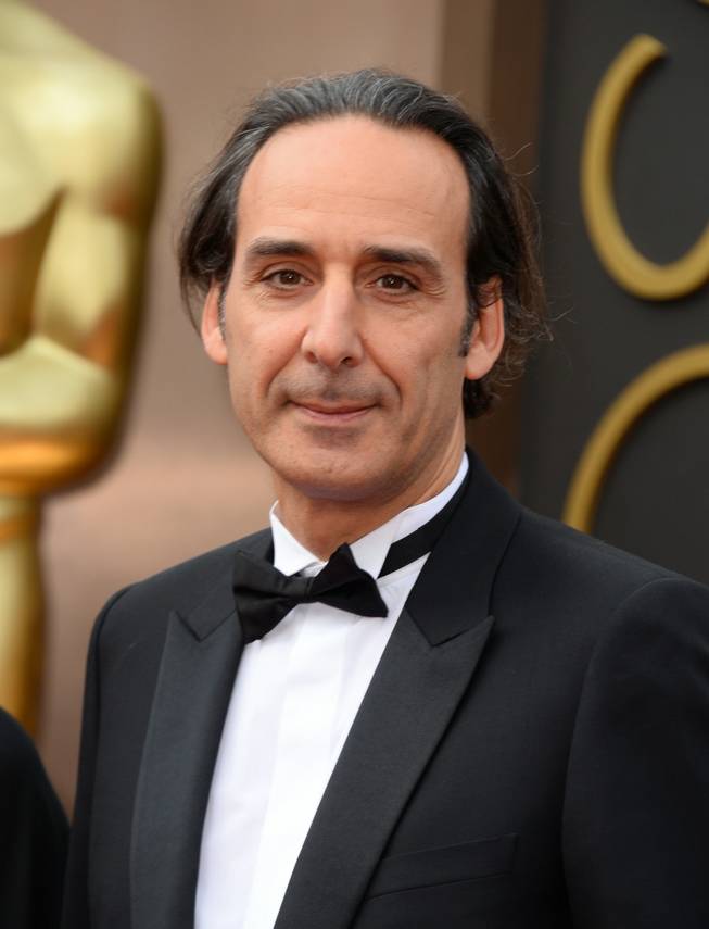 Alexandre Desplat arrives at the Oscars on Sunday, March 2, 2014, at the Dolby Theatre in Los Angeles.  (Photo by Jordan Strauss/Invision/AP)