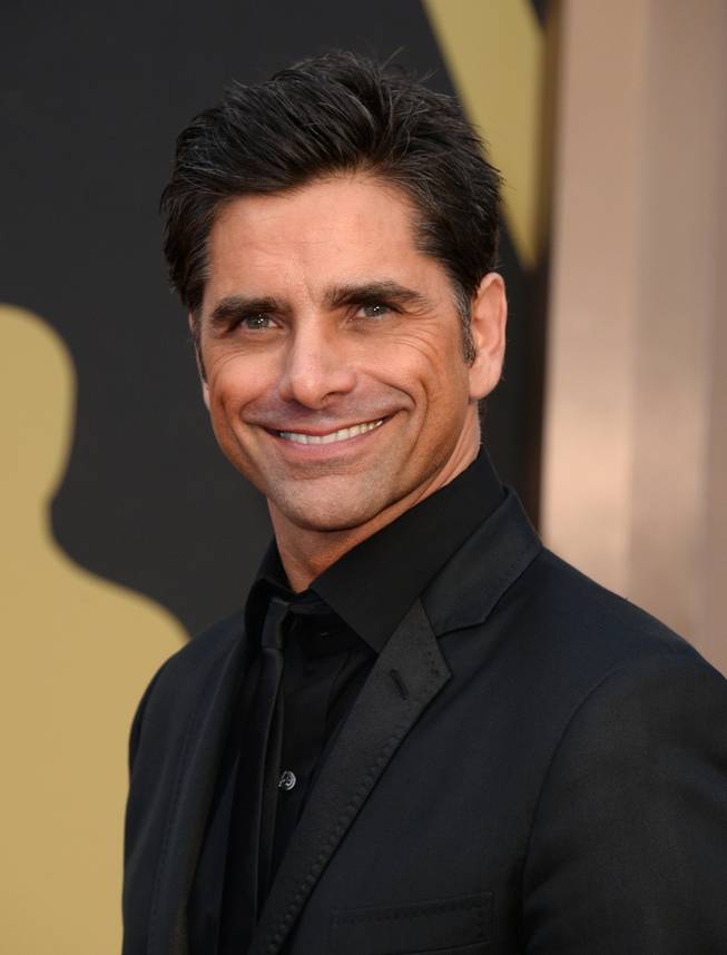 John Stamos arrives at the Oscars on Sunday, March 2, 2014, at the Dolby Theatre in Los Angeles.  (Photo by Jordan Strauss/Invision/AP)