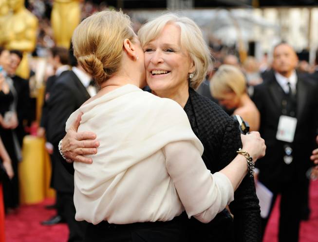 Meryl Streep, left, and Glenn Close arrive at the Oscars on Sunday, March 2, 2014, at the Dolby Theatre in Los Angeles.  (Photo by Chris Pizzello/Invision/AP)