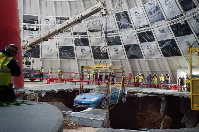 One of eight Chevrolet Corvettes is removed from a sinkhole in the Skydome at the National Corvette Museum on Monday, March. 3, 2014, in Bowling Green, Ky. 