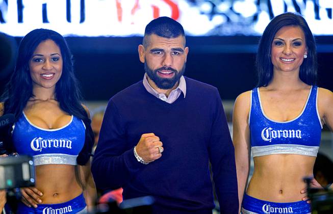 Light middleweight boxers Alfredo Angulo of Mexico poses with Corona Girls in the MGM Grand lobby Tuesday, March 4, 2014. Angulo will take on Canelo Alvarez, also of Mexico, in a non-title, 12-round fight at the MGM Grand Garden Arena on Saturday.