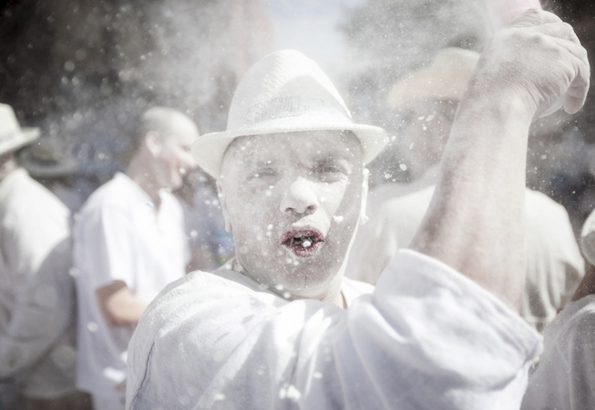 Revellers known as 'Los Indianos', throw talcum powder over each ...