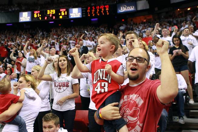 UNLV fans Patrick Amico and his son Trey Amico cheer late in their game against San Diego State Wednesday, March 5, 2014 at the Thomas & Mack Center. The Aztecs won 73-64.