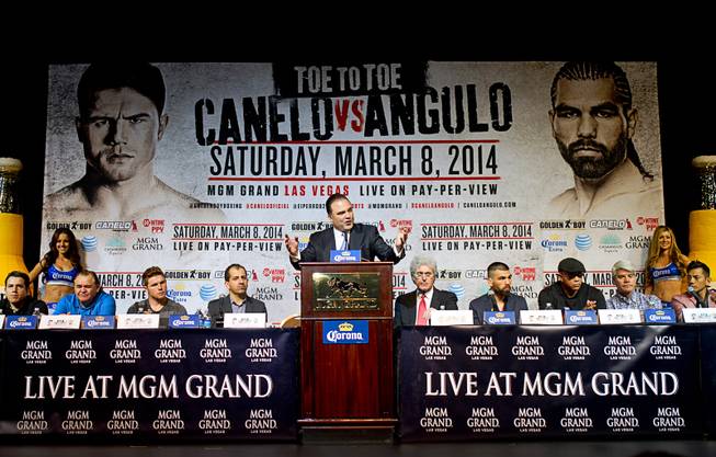 Richard Schaefer, center, CEO of Golden Boy Promotions, speaks during a news conference at the MGM Grand Thursday, March 6, 2014. Canelo Alvarez and Alfredo Angulo, both of Mexico, will fight at the MGM Grand Garden Arena on Saturday.