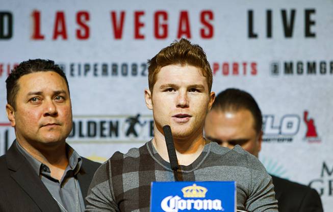 Super welterweight boxer Canelo Alvarez, center, speaks during a news conference at the MGM Grand Thursday, March 6, 2014. Alvarez and Alfredo Angulo, both of Mexico, will fight at the MGM Grand Garden Arena on Saturday. Alvarez is a former WBC and WBA 154 lb. champion.