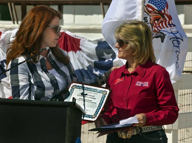 Councilwoman Debra March of Henderson Ward II presents Sydney Knott with a certificate of congratulations for her determination in making Horses4Heroes a reality at Tule Springs on Thursday, March 06, 2014. They are a nonprofit that treats military vets, police officers, first responders and children dealing with psychological or physical issues through equestrian therapy.
