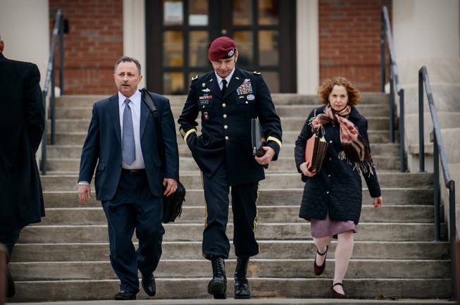 Brig. Gen. Jeffrey Sinclair leaves the courthouse with his lawyers Richard Scheff, left, and Ellen C. Brotman, following a day of motions Tuesday, March 4, 2014, at Fort Bragg, N.C.