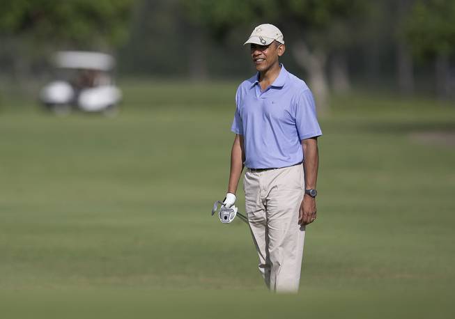 President Barack Obama looks to the second green as he golfs at Kaneohe Klipper Golf Course on Marine Corps Base Hawaii, in Kaneohe Bay, Hawaii, Thursday, Jan. 2, 2014. 