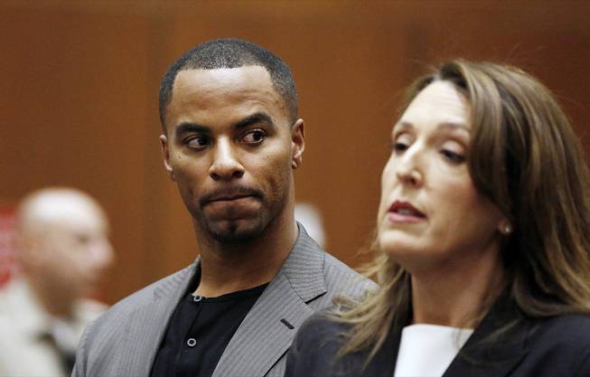 Former NFL safety Darren Sharper looks toward his attorney Blair Berk during an appearance in Los Angeles Superior Court in Los Angeles, where he pleaded not guilty Thursday, Feb. 20, 2014, to charges of drugging and raping two women.