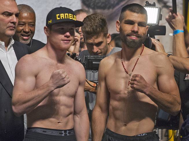 Canelo Alvarez and opponent Alfredo "El Perro" Angulo face their fans following their weigh-ins at the MGM Grand Garden Arena on Friday, March 7, 2014. 