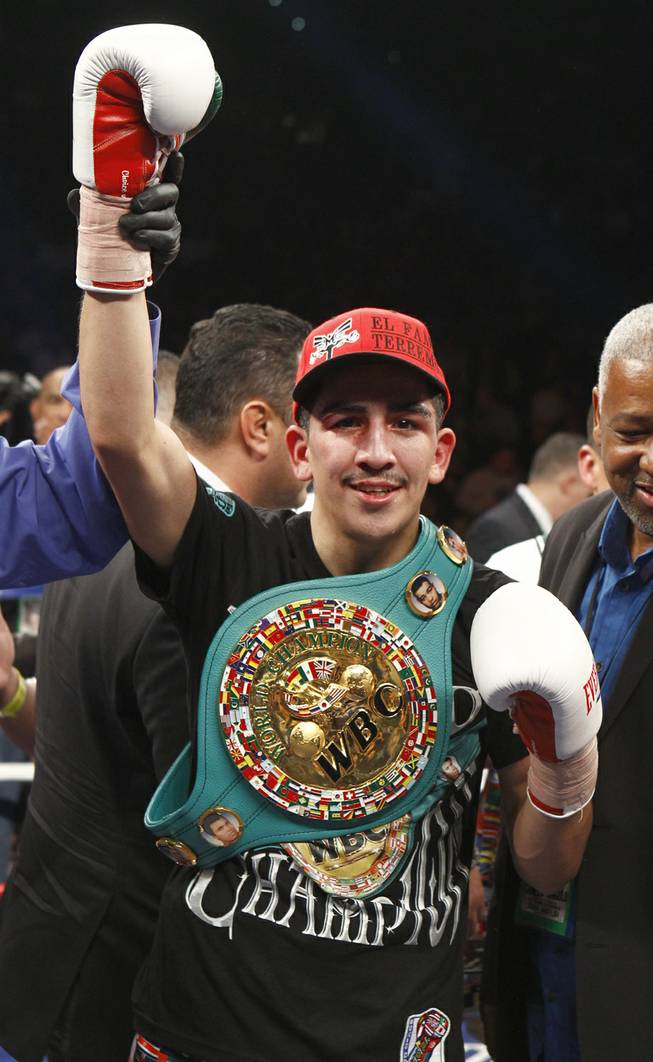 WBC super bantamweight champion Leo Santa Cruz celebrates his victory over Cristian Mijares, both of Mexico, after their title fight at the MGM Grand Garden Arena on Saturday, March 8, 2014.