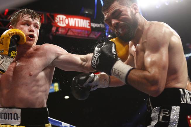 Canelo Alvarez, left, connects on Alfredo Angulo, both of Mexico, during their super-welterweight fight Saturday, March 8, 2014, at  MGM Grand Garden Arena