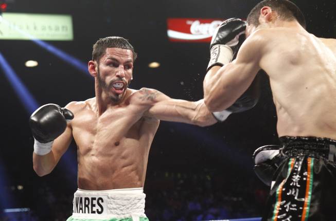 Jorge Linares, left, of Venezuela punches throws a punch at Nihito Arakawa of Japan during their lightweight fight at the MGM Grand Garden Arena on Saturday, March 8, 2014.