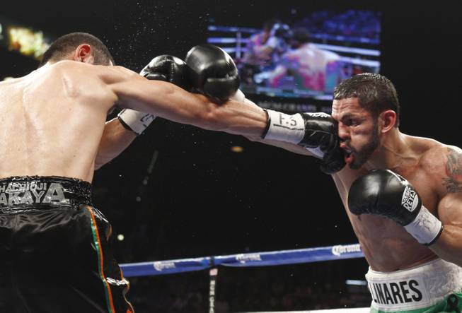 Nihito Arakawa of Japan connects on Jorge Linares of Venezuela during their lightweight fight at the MGM Grand Garden Arena on Saturday, March 8, 2014.