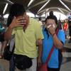 A woman wipes her tears after walking out of the reception center and holding area for family and friends of passengers aboard a missing Malaysia Airlines plane at Kuala Lumpur International Airport in Sepang, Malaysia, on Saturday, March 8, 2014. 