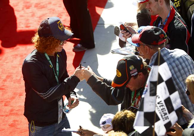 Comedian Carrot Top visits with fans before the Kobalt 400 NASCAR Sprint Cup Series race at the Las Vegas Motor Speedway Sunday, March 9, 2014.