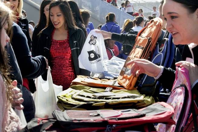 Students also receive new backpacks and t-shirts during the Goodie Two Shoes Foundation event at the Thomas & Mack Center Tuesday, March 11, 2014.  