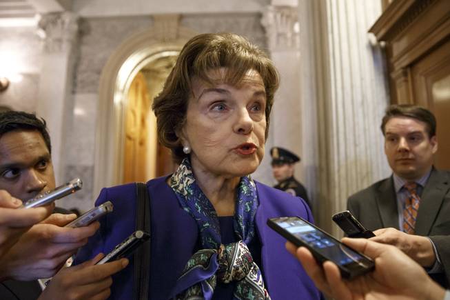 Senate Intelligence Committee Chair Sen. Dianne Feinstein, D-Calif. talks to reporters as she leaves the Senate chamber on Capitol Hill in Washington, Tuesday, March 11, 2014.