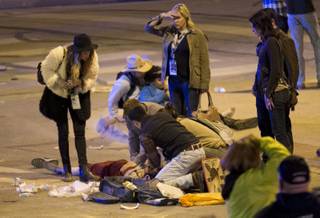 People perform CPR on a woman after she was struck by a vehicle on Red River Street in downtown Austin, Texas, at SXSW on Wednesday March 12, 2014. Her condition is unknown. Police say two people have died after a car drove through temporary barricades set up for the South By Southwest festival and struck a crowd of pedestrians.