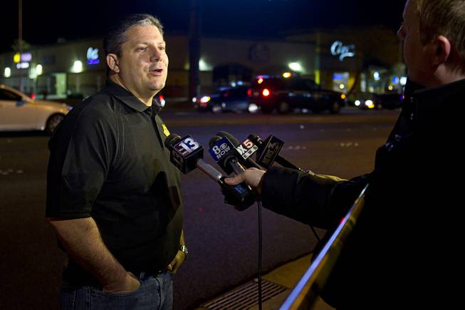 Metro Police Lt. Ray Stieber responds to questions from reporters after a shooting victim was involved in an accident at the 1-215 eastbound off-ramp at Eastern Avenue Thursday, March 13, 2014. The driver, who had been shot multiple times, may have been shot at another location, police said.