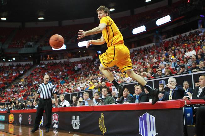 Wyoming guard Riley Grabau leaps as he tries to keep the ball inbounds during their Mountain West Conference tournament game against UNLV Thursday, March 13, 2014 at the Thomas & Mack Center.