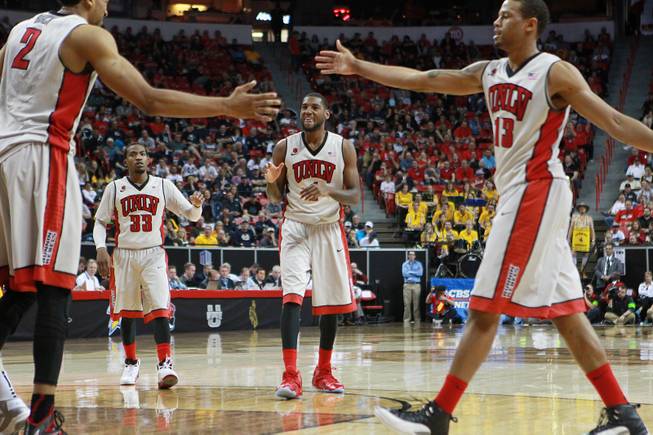 UNLV's Khem Birch, Deville Smith, Roscoe Smith and Bryce Dejean-Jones celebrate an and-one against Wyoming during their Mountain West Conference tournament game Thursday, March 13, 2014, at the Thomas & Mack Center. UNLV won the game 71-67.