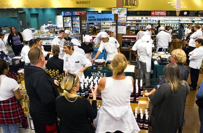 Family members and supporters watch as students prepare their selected meals during the Culinary Collision at the Whole Foods Market in Town Square on Thursday, March 13, 2014.