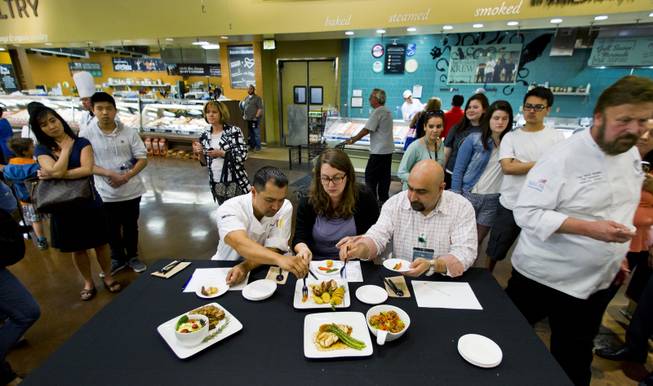 The Culinary Collision judges chef Lloyd Bansil, Rachel Safran and Raffi Ghanimian taste the finished meals to be rated during the competition at the Whole Foods Market in Town Square on Thursday, March 13, 2014.