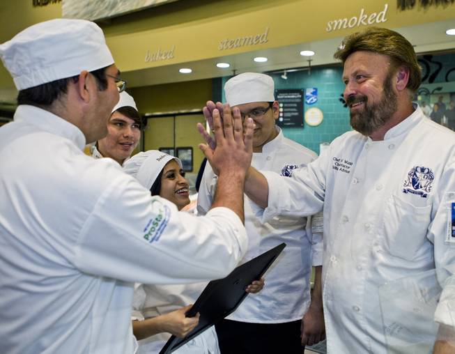 East Career and Technical Academy students and their culinary instructor David Watkins celebrate their win in the Culinary Collision at the Whole Foods Market in Town Square on Thursday, March 13, 2014.