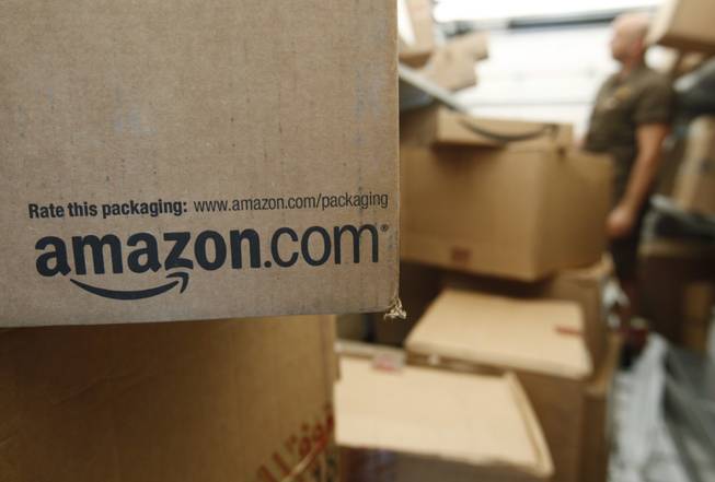 In this Oct. 18, 2010, file photo, an Amazon.com package awaits delivery from UPS in Palo Alto, Calif. 