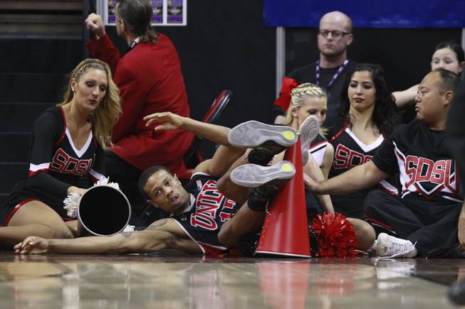 UNLV guard Bryce Dejean Jones falls into the San Diego State cheerleaders during their Mountain West Conference semifinal game Friday, March 14, 2014 at the Thomas & Mack Center. The #8 ranked San Diego State Aztecs won 59-51 to advance to the finals.