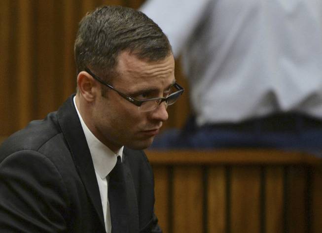 Oscar Pistorius sits in the dock during his murder trial at a court in Pretoria, South Africa, Friday, March 14, 2014. Pistorius is charged with the shooting death of his girlfriend Reeva Steenkamp, on Valentines Day in 2013.
